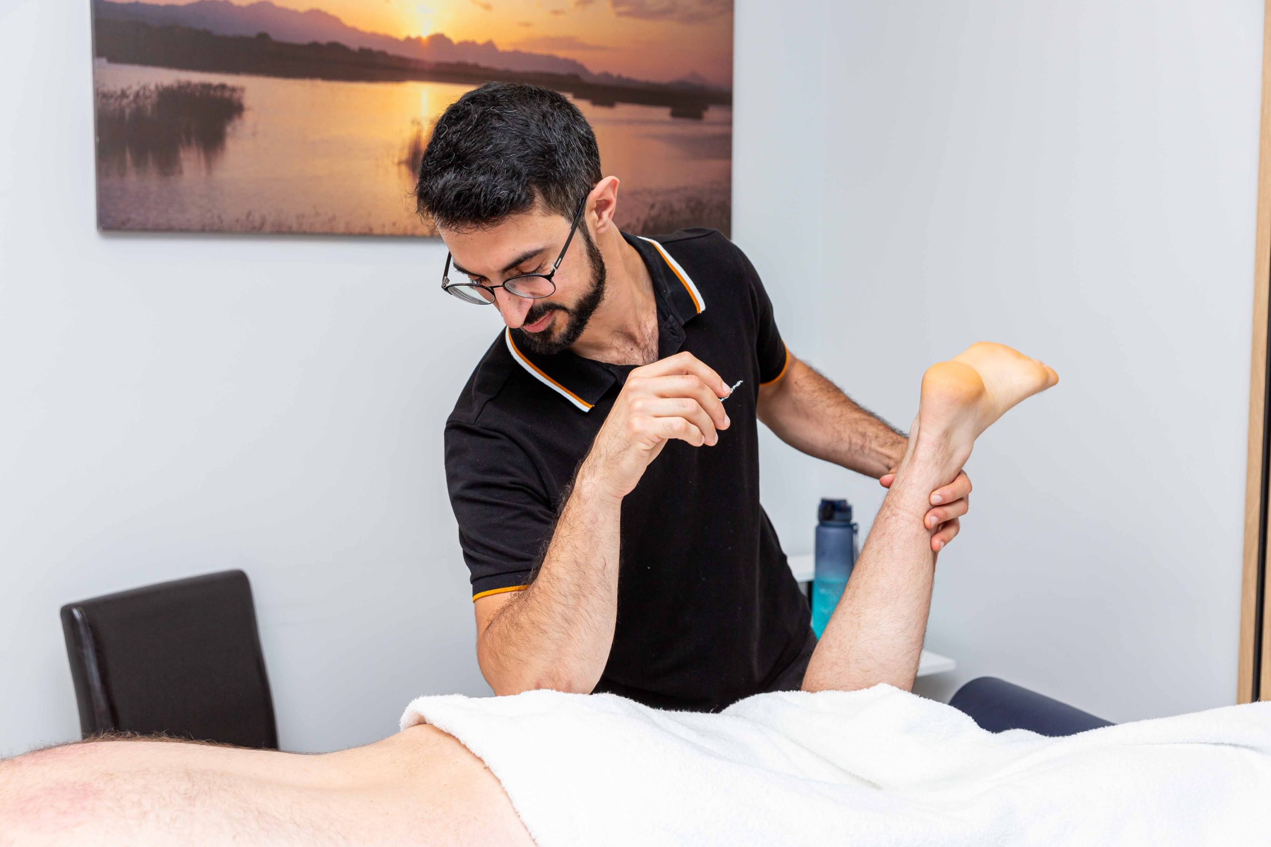 Luke giving sports massage in New Malden clinic