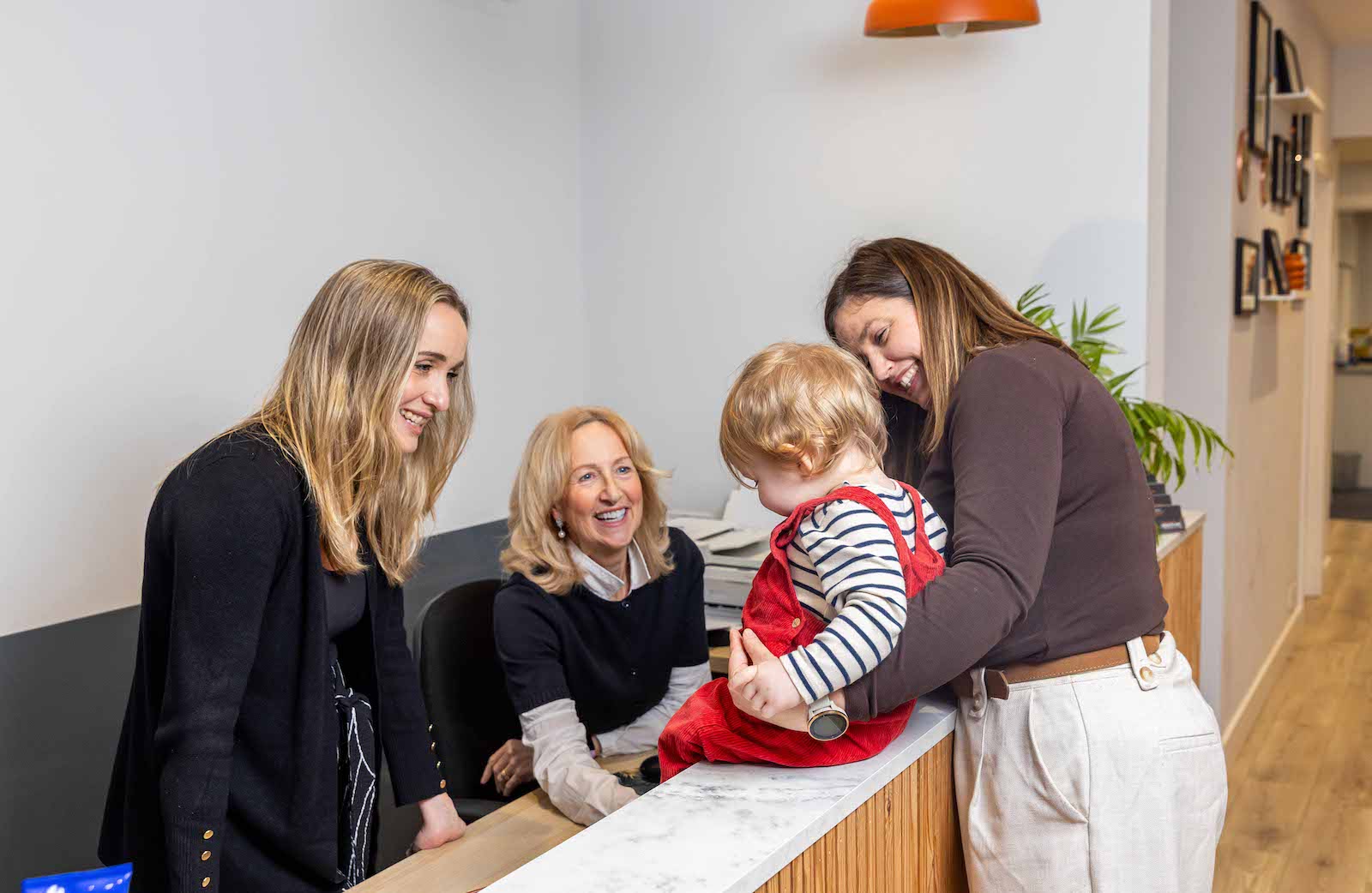New Malden Health and Performance Clinic Reception with toddler for paediatric chiropractic